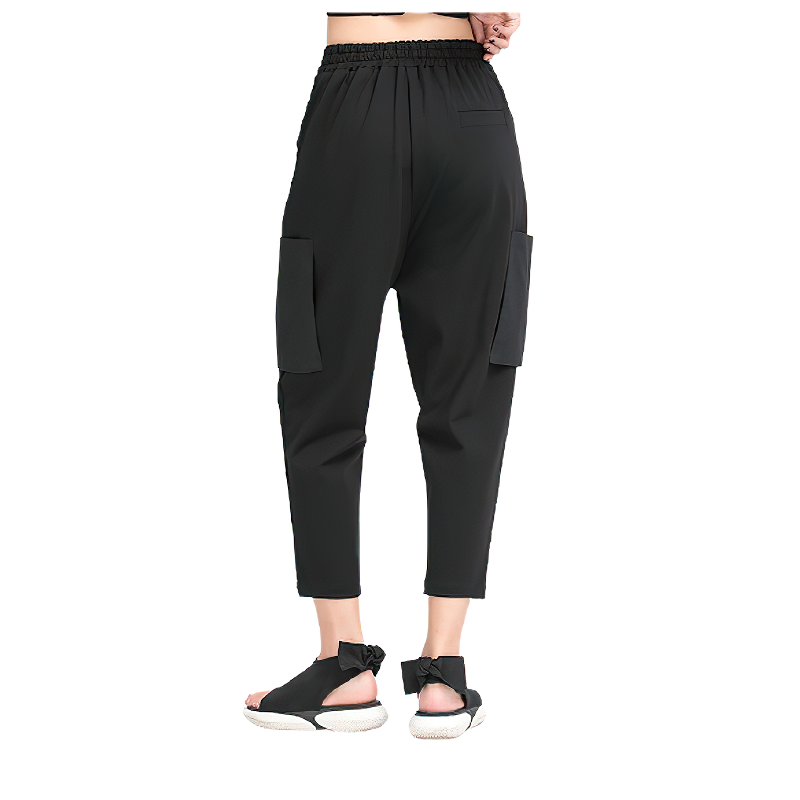 Trendy black spliced women's harem pants with pockets, perfect for alternative fashion lovers.