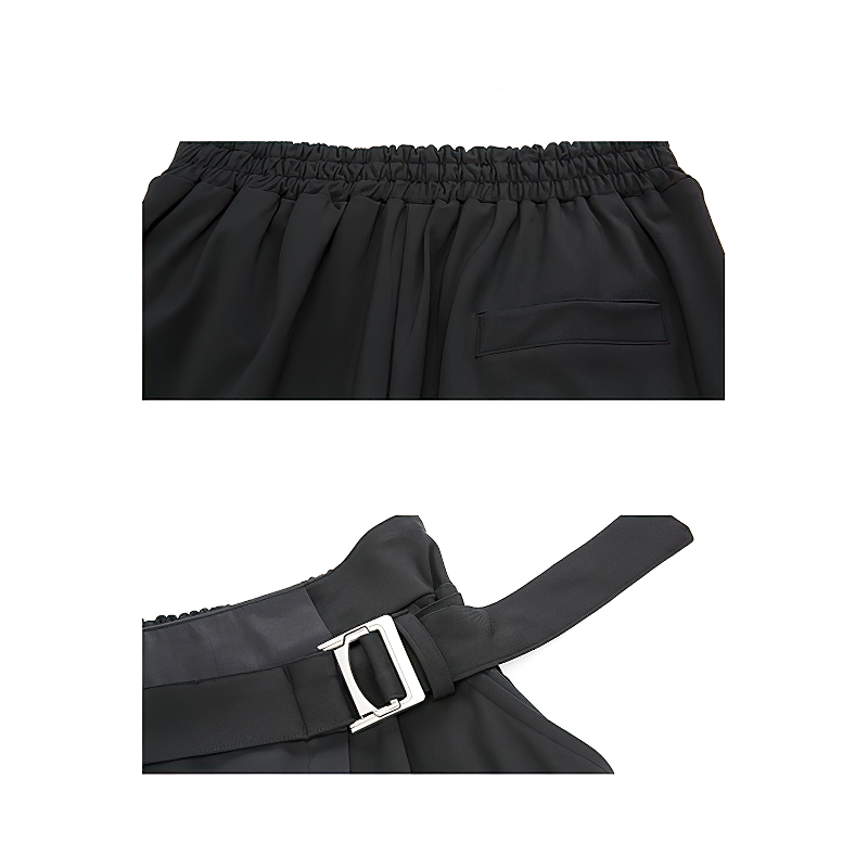 Close-up of black spliced women's harem pants showing waistband and metal buckle for adjustable fit.