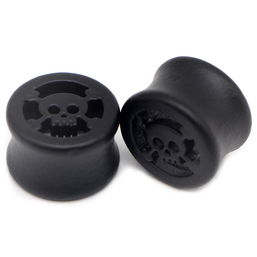 Black wood plugs with skull design for body piercing, perfect for punk rock style and unisex fashion.