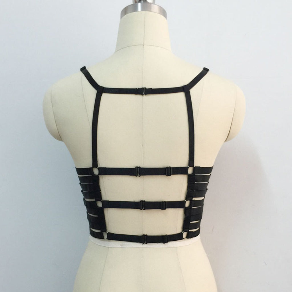 Back view of a black strappy cage bra body harness, showcasing its gothic style and adjustable straps.