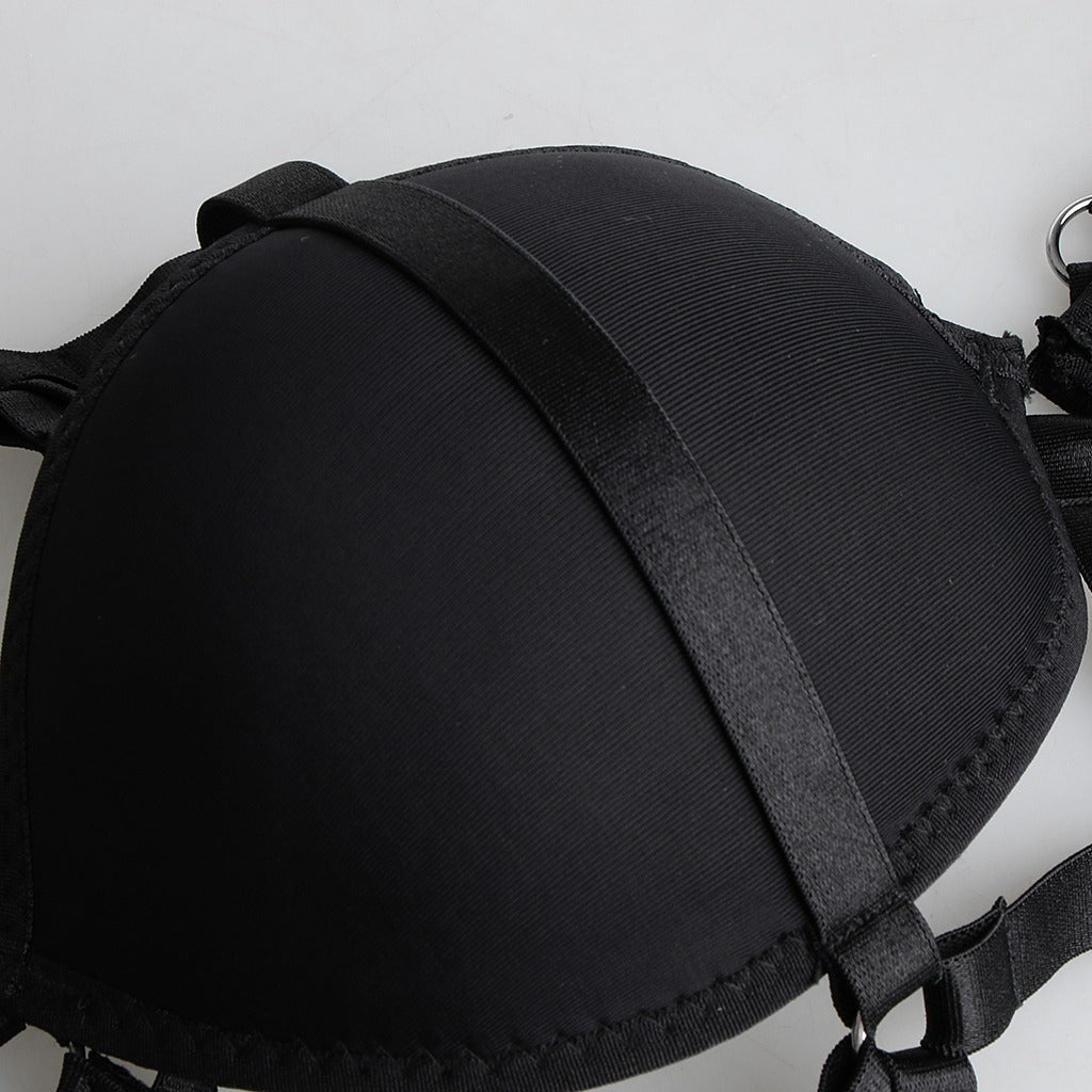 Black strappy cage bra body harness, gothic style crop top accessory, made of nylon for versatile styling.