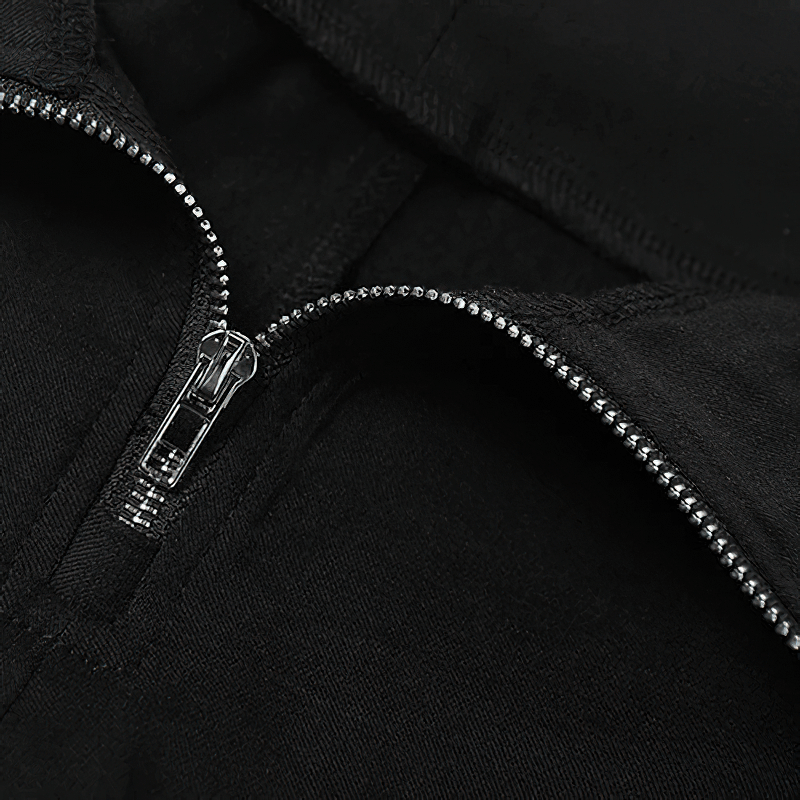 Close-up of the zipper detail on black high-waisted flared trousers, showcasing stylish alternative apparel features.