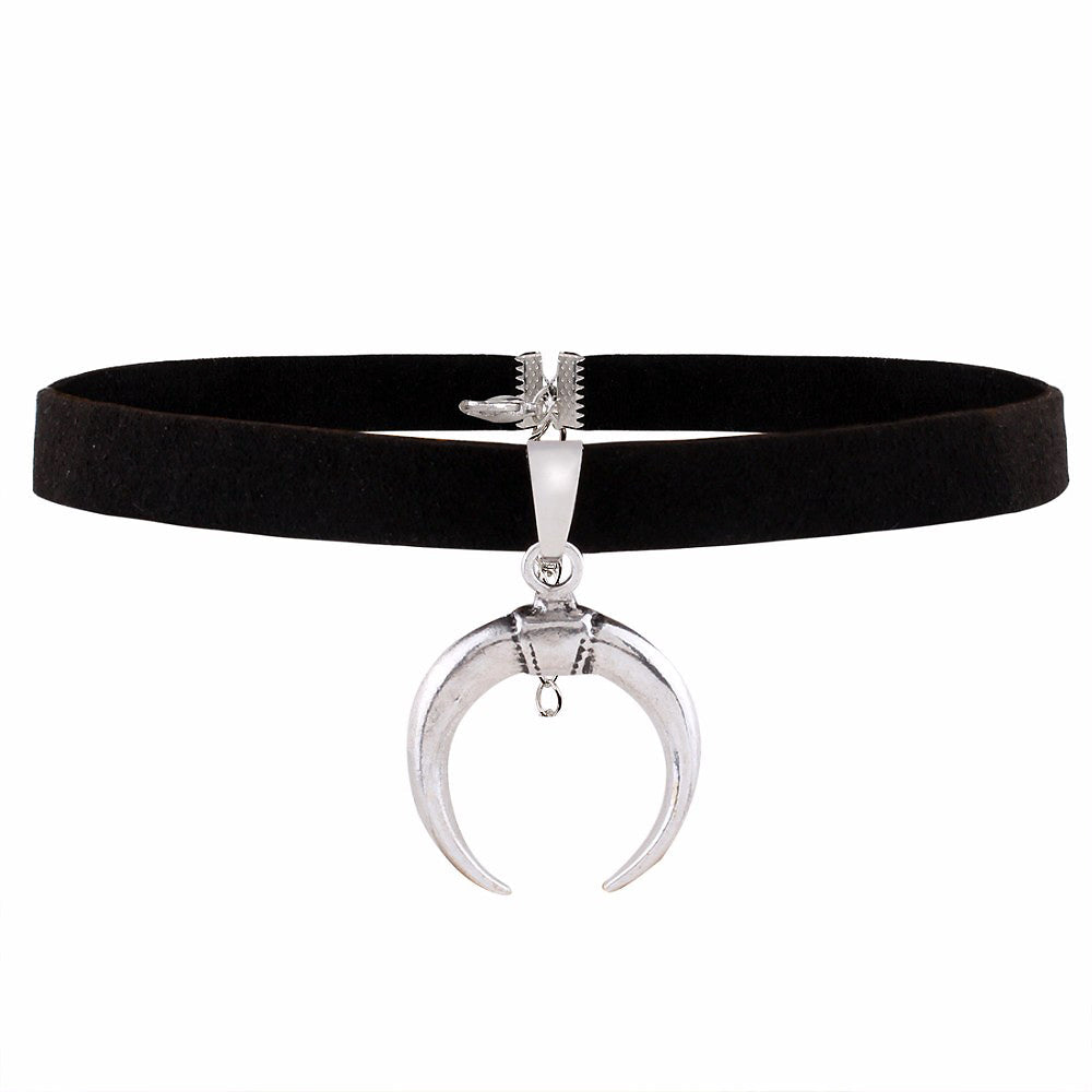 Black velvet choker with silver half-moon charm, perfect gothic accessory for any outfit.