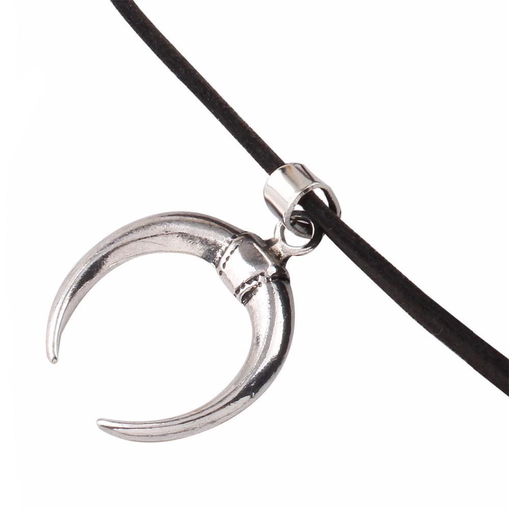 Silver moon pendant on black velvet choker, gothic style charm for unique accessories and vintage looks.