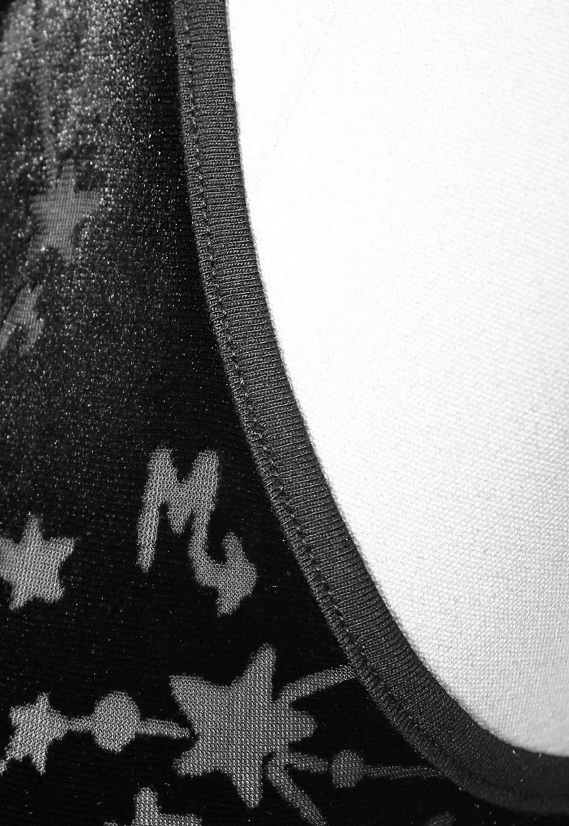 Close-up of black velvet tank top showcasing embroidered neckline and astrology pattern, perfect for gothic style.