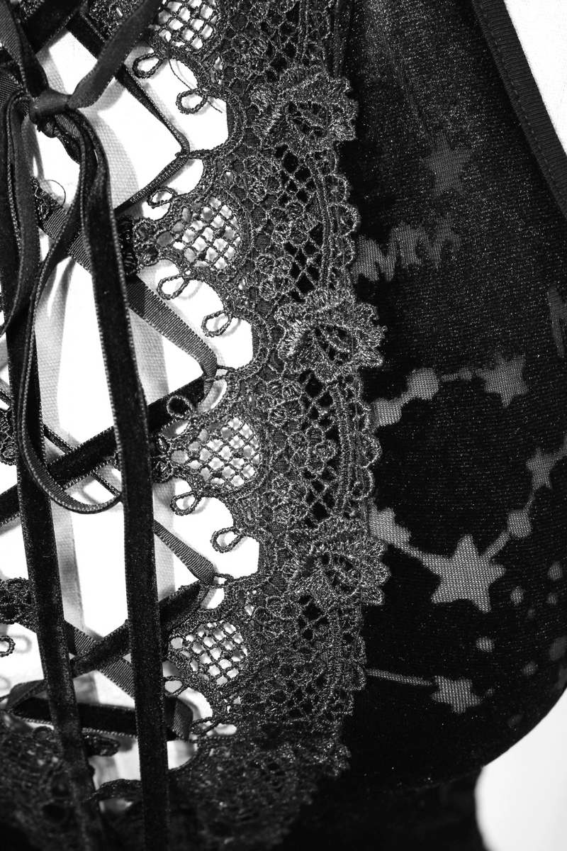 Close-up of black velvet tank top featuring embroidered neckline and astrology patterns, perfect for gothic fashion lovers.