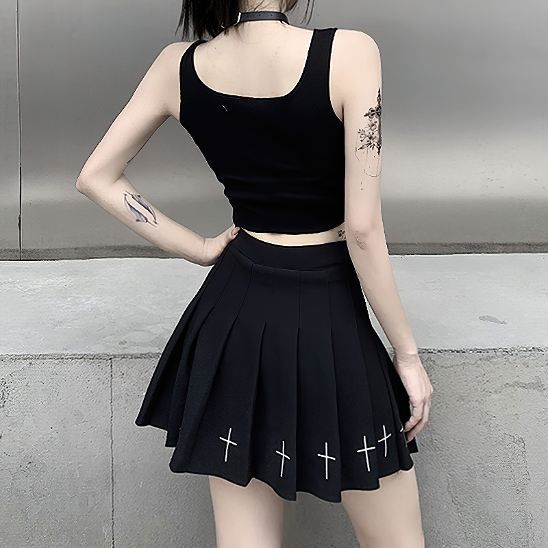 Black sleeveless tank top paired with a pleated black skirt featuring cross prints, perfect for alternative summer fashion.