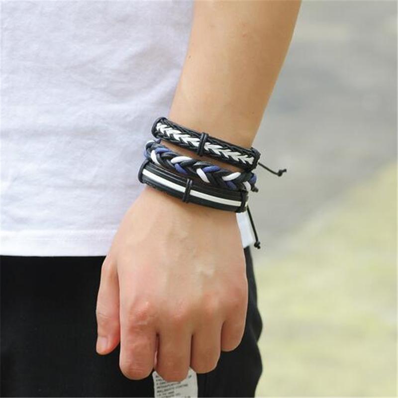 Black and white leather braided bracelet set on a man's wrist, showcasing a rock style and trendy design.