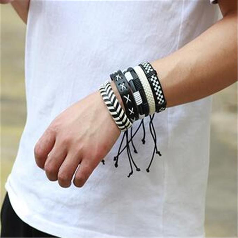 Black and white leather bracelet set of 5 worn on a wrist, showcasing rock style design and versatility for men and women.