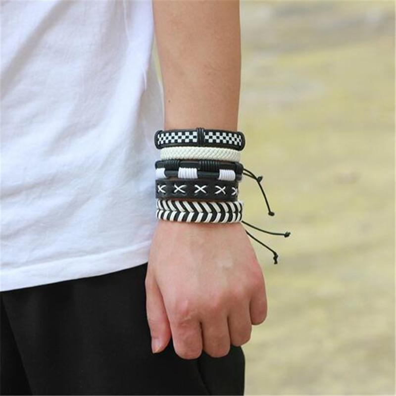 Black and white leather bracelet set of 5, stylish rock wristband worn on a male wrist, versatile accessory.