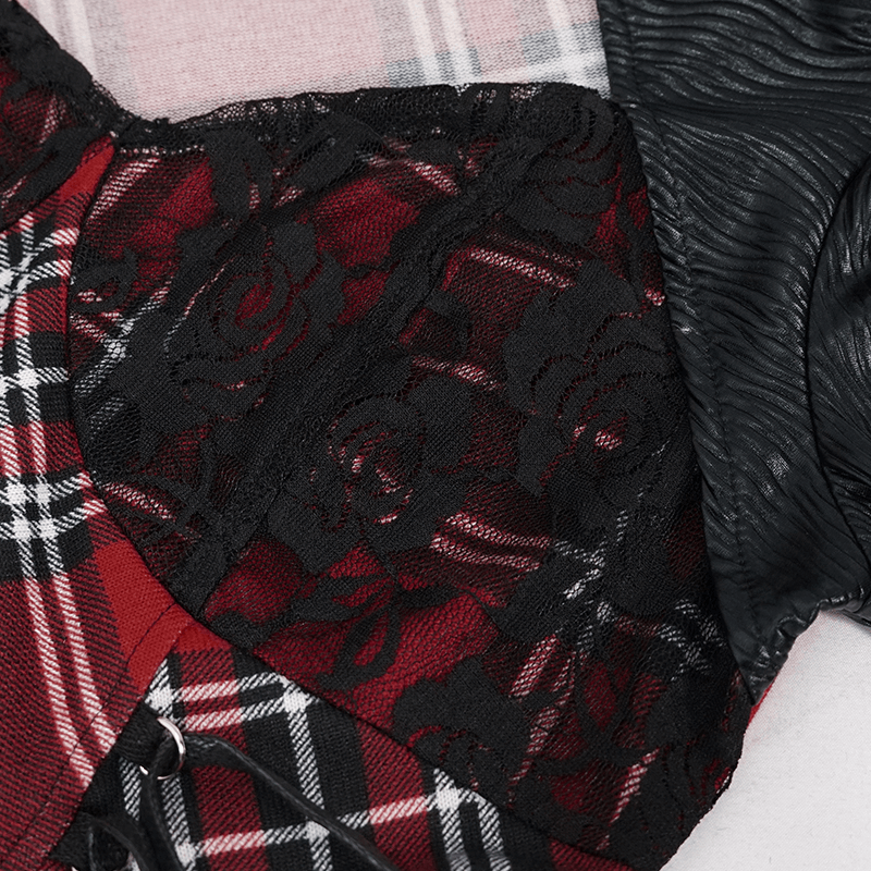 Close-up of black lace and red checkered fabric featuring punk style details on a women's dress.