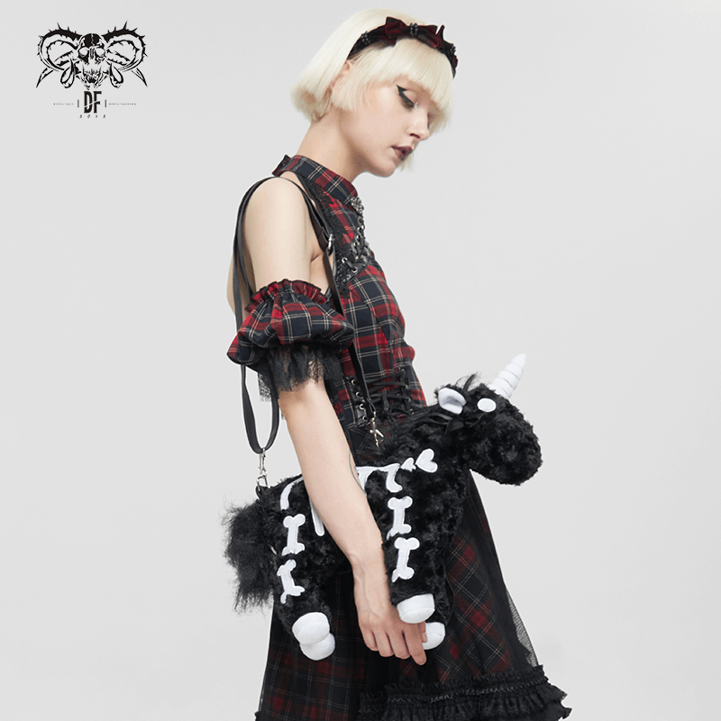 Model showcasing a black plush unicorn handbag with white bones pattern, perfect for a gothic fashion statement.