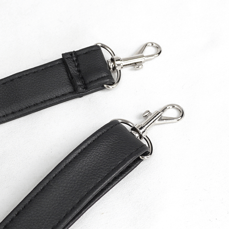Close-up of black handbag strap with silver clasps, showcasing a stylish and durable design for gothic accessories.