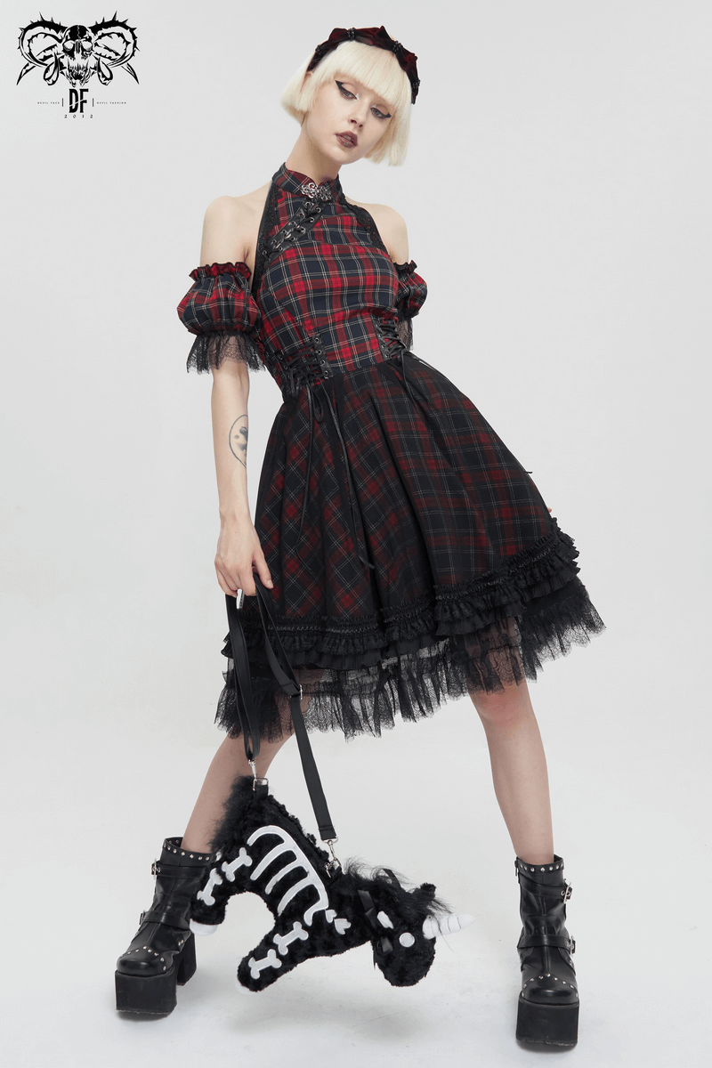 Stylish model in a plaid gothic dress with black lace and platform boots, holding a plush unicorn handbag with white bones.