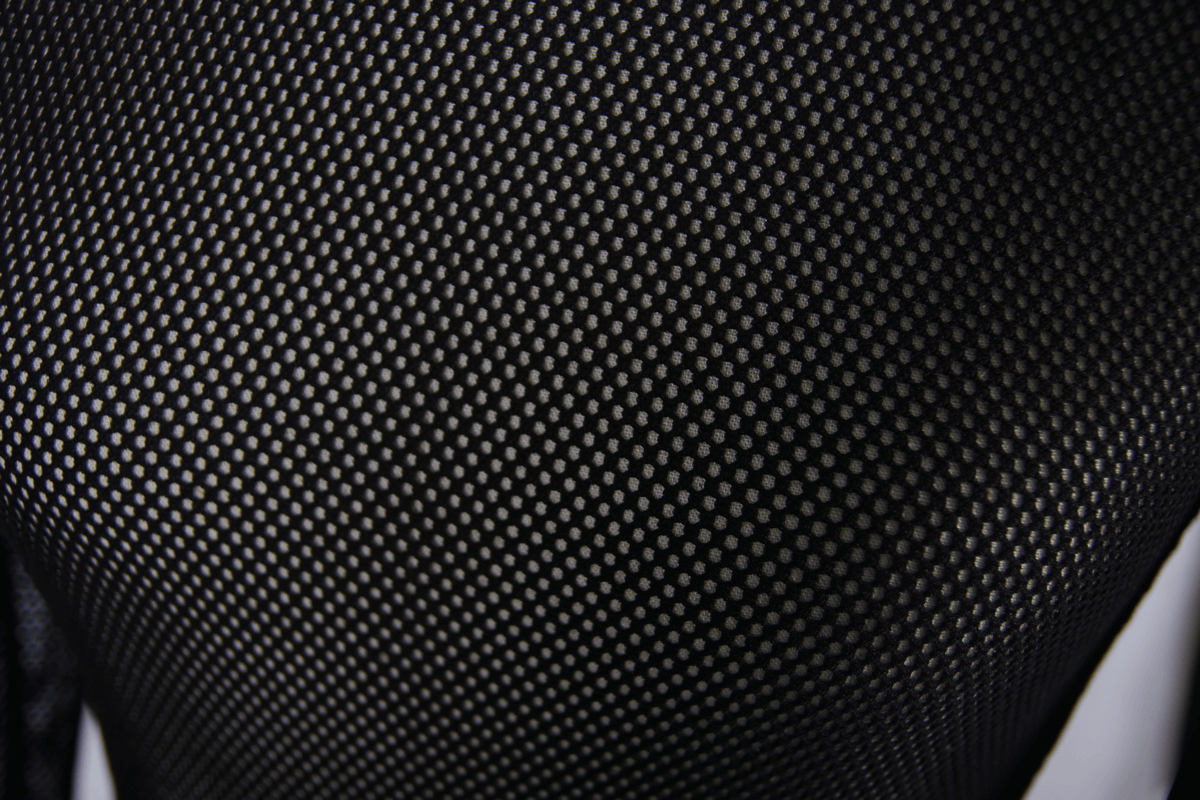 Close-up of black mesh fabric showing a stylish design for women's long sleeve tops.