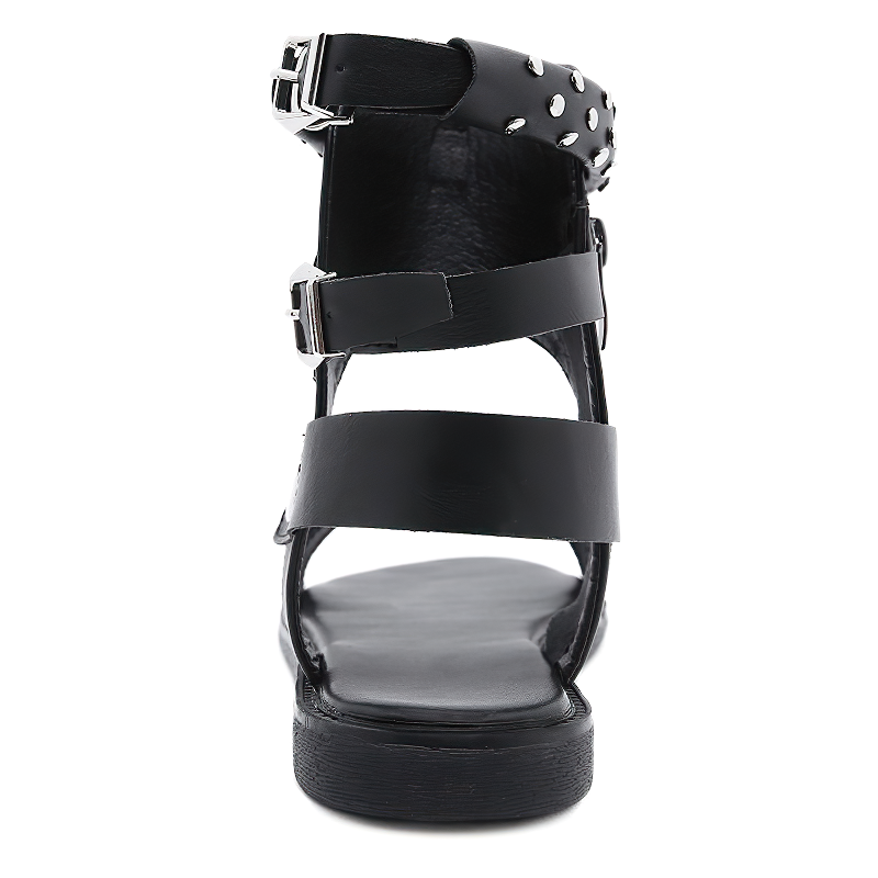 Stylish black women's flat sandals with ankle strap, metal rivets, and a comfortable PU leather design.