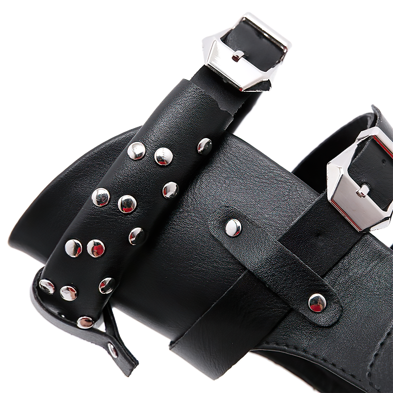 Close-up of black women's flat sandals featuring metal rivets and adjustable ankle strap for stylish summer footwear.