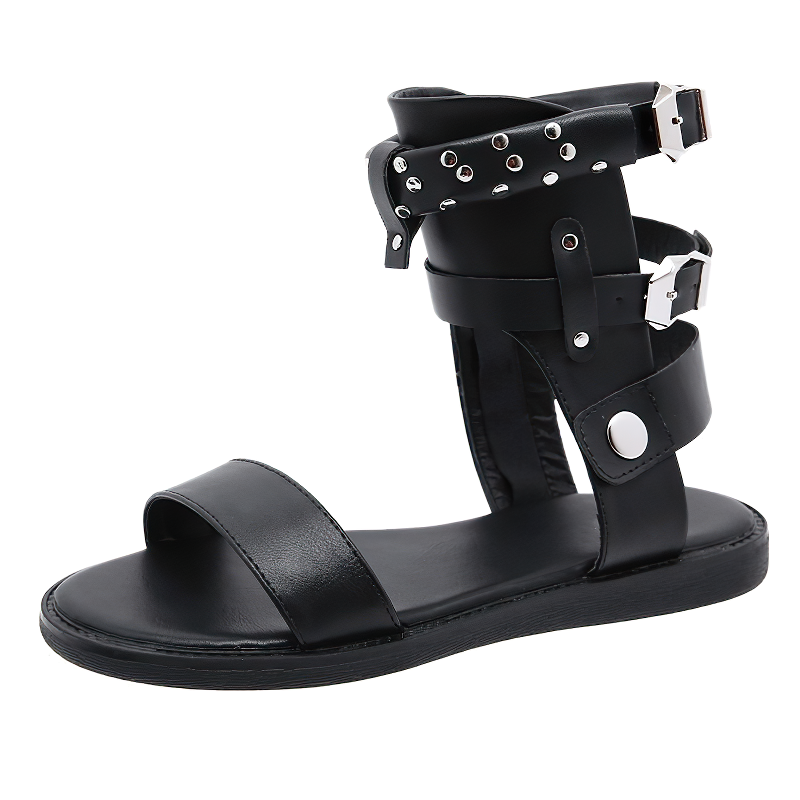 Stylish black flat sandals for women with ankle strap, metal rivets, and comfortable PU leather design.