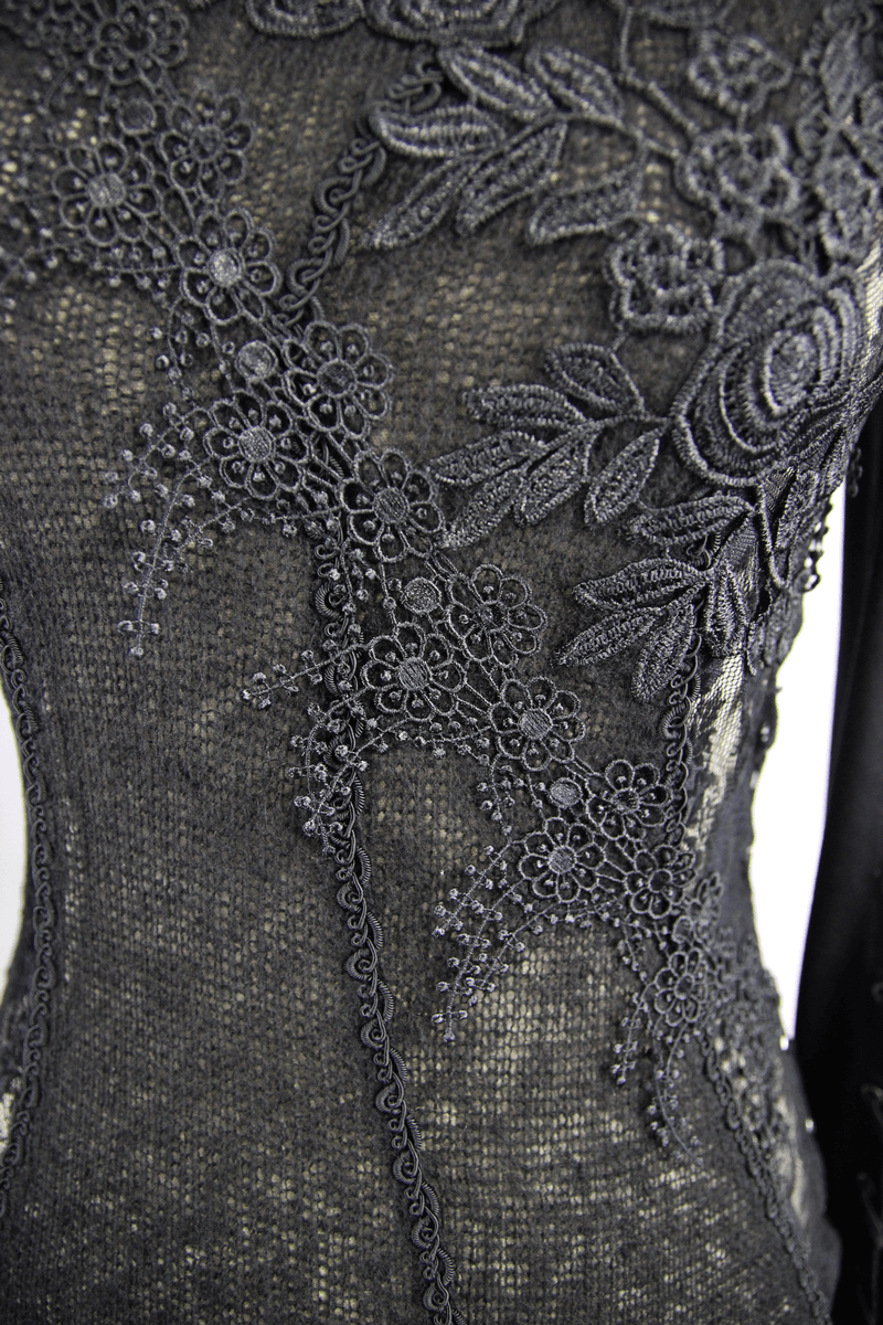 Close-up of black women's lace top featuring intricate floral embroidery in gothic style.