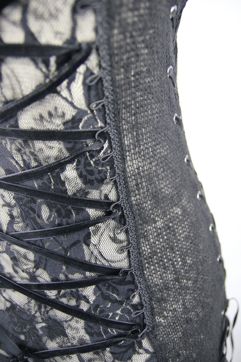 Close-up of a black lace top featuring gothic style and intricate asymmetrical design with detailed lacing.