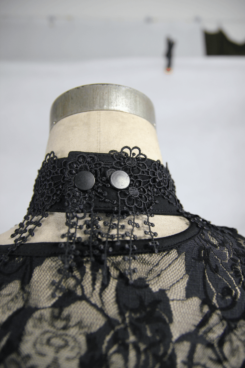 Back view of black lace top showcasing intricate embroidery and stylish button details, perfect for gothic fashion lovers.