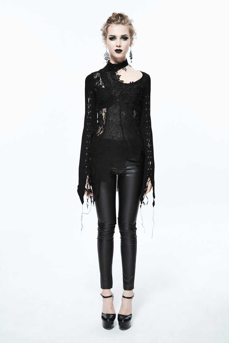 Stylish woman in a black lace asymmetric top and leather pants, showcasing gothic elegance and modern fashion.