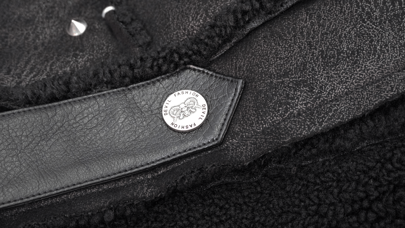 Close-up of a black PU leather jacket with studs, showcasing a stylish tag and soft fur lining.