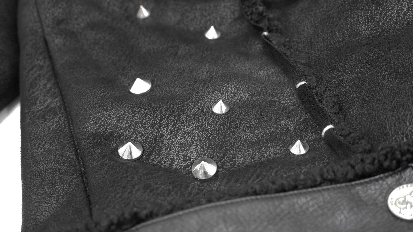 Close-up of silver studs on a black PU leather jacket, featuring a textured design and punk fashion elements.
