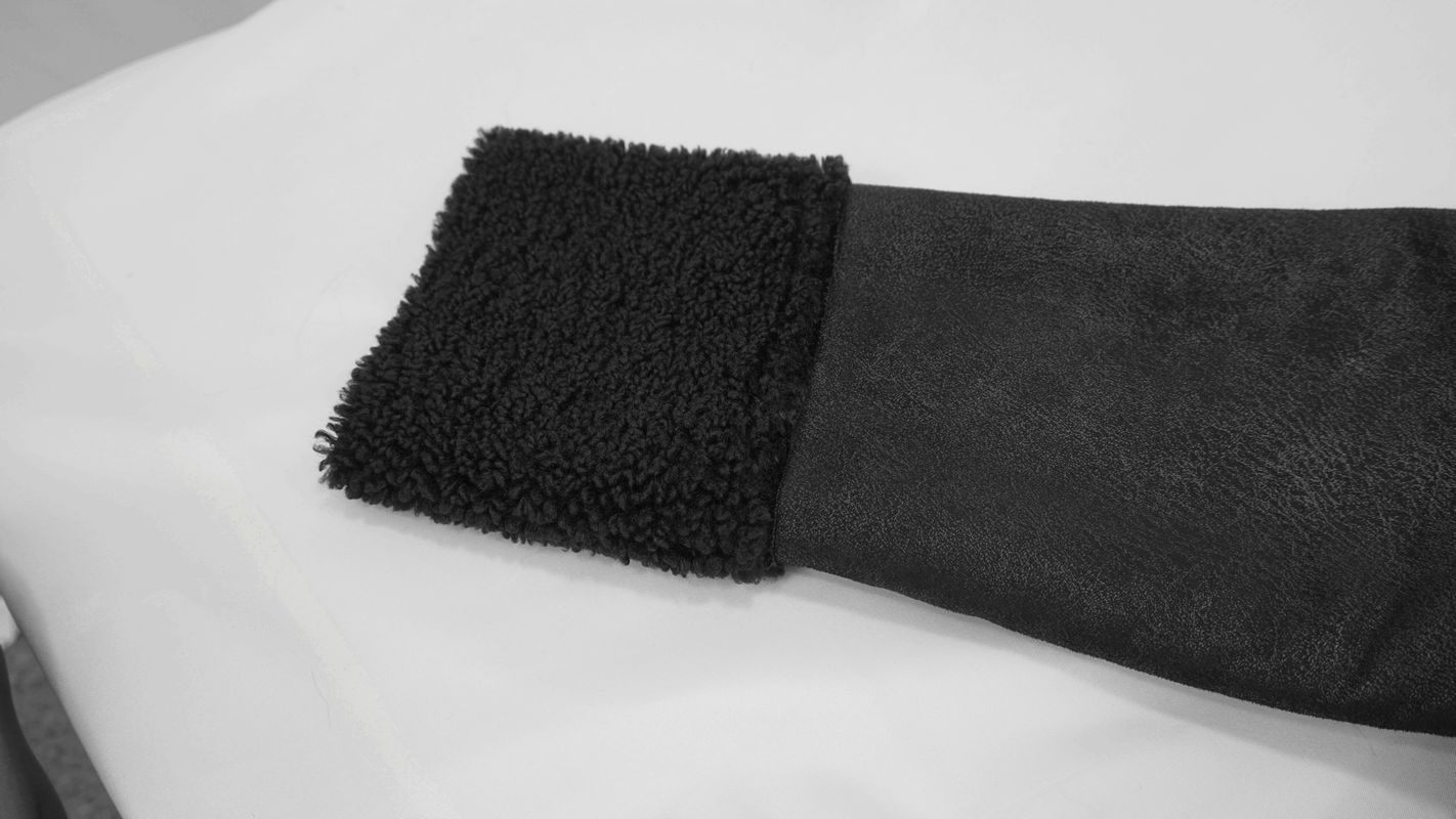 Close-up of the cozy fur collar on a black PU leather jacket, showcasing its stylish punk design with soft texture.