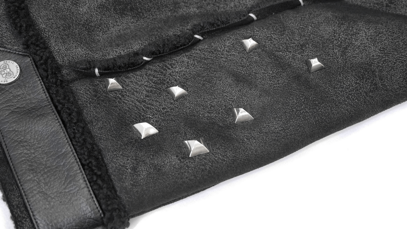 Close-up of black jacket fur collar detail with silver studs and accents for punk fashion lovers.