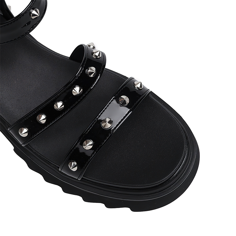 Close-up of black zipper open toe platform sandals with silver studs, perfect for punk style fashion.