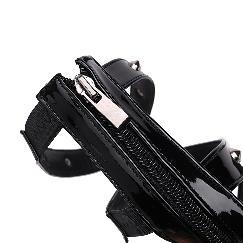 Close-up of black zipper detail on open toe platform shoes with stylish straps and punk flair.