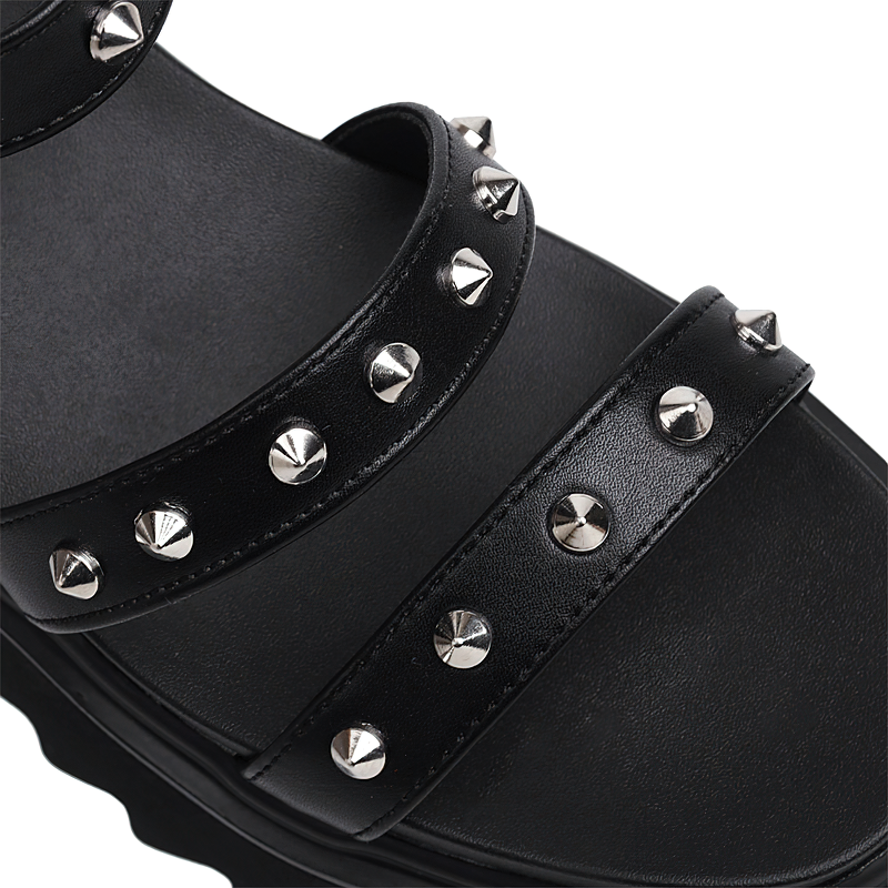 Close-up of black zipper open toe platform sandals with stylish silver studs and supportive straps.