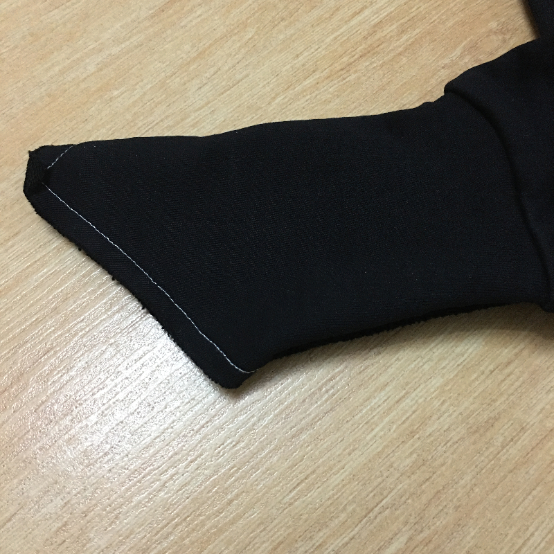 Close-up of the unique long sleeve design of a black zipper hoodie, featuring stylish cut details and stitching.