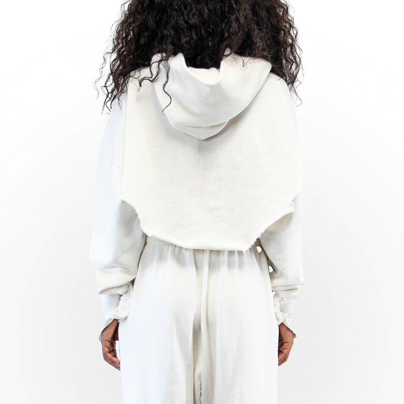 Back view of a cozy white cropped hoodie with a hood, featuring relaxed sleeves and stylish hemline details.