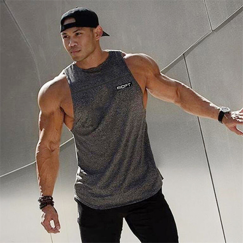 Stylish bodybuilding tank top for men, showcasing athletic design and comfortable cotton fabric in urban setting.