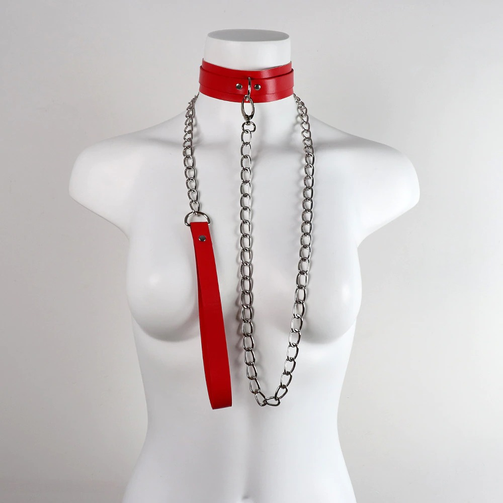 Red bondage collar with metal chain and leather leash on a mannequin, perfect for cosplay and theme parties.