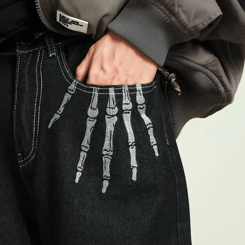 Men's bone print jeans featuring a stylish skeleton hand design on the pocket, perfect for alternative fashion.