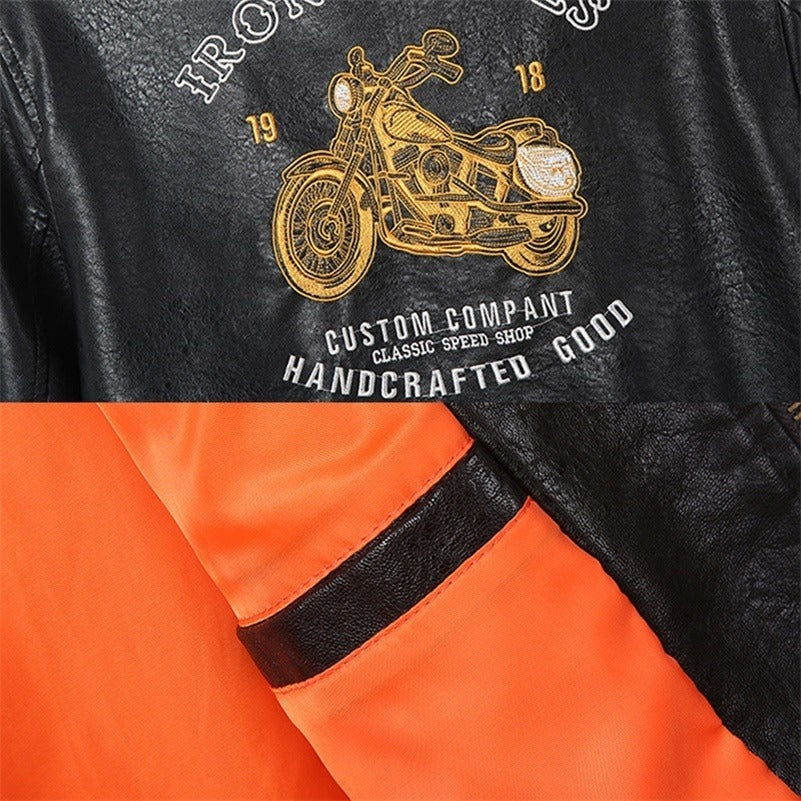 Detail of men's Born to Ride faux leather biker jacket featuring motorcycle graphic and vibrant orange lining.
