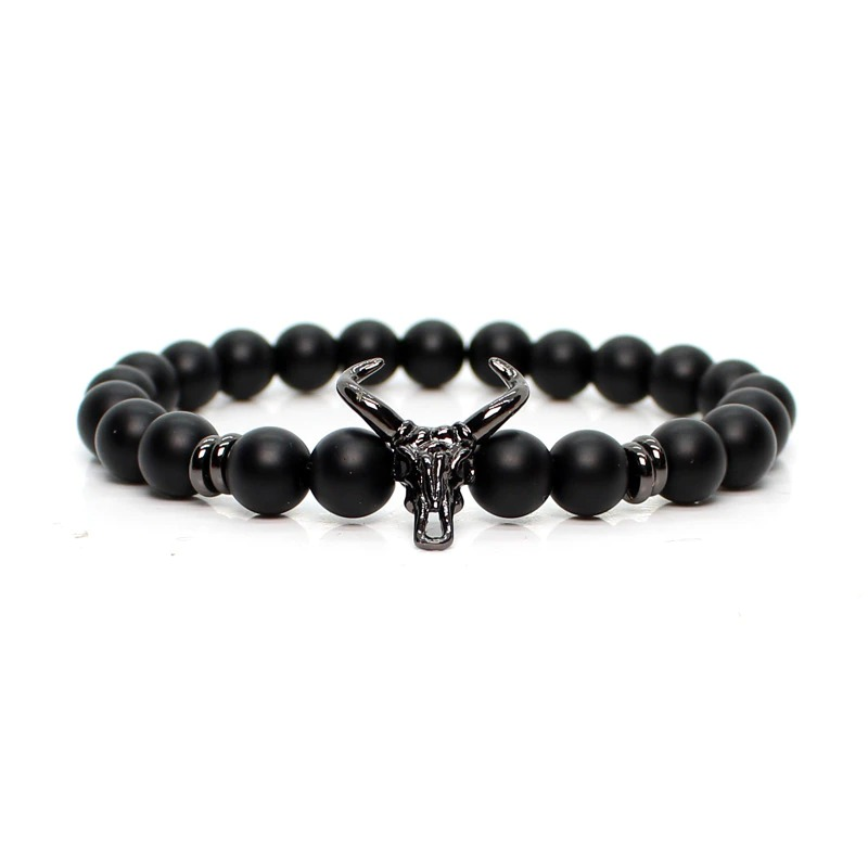 Stylish men's bracelet with black stone beads and silver skull centerpiece, ideal for modern fashion.