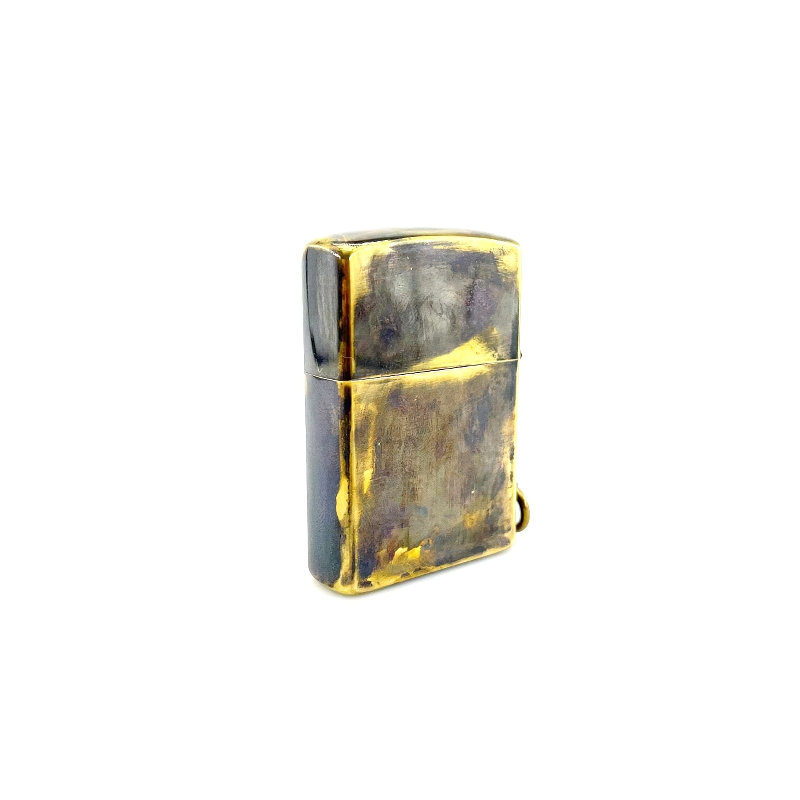 Brass portable lighter case with a unique worn finish, featuring a stylish samurai skull design.