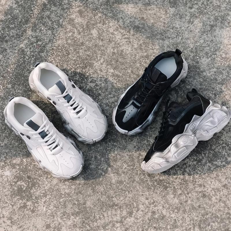 Stylish white and black breathable genuine leather women's sneakers on a textured surface, perfect for casual wear.