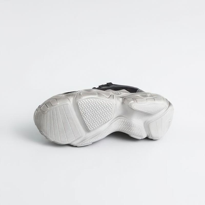 Bottom view of breathable genuine leather women's sneakers showcasing the rubber sole and traction design.