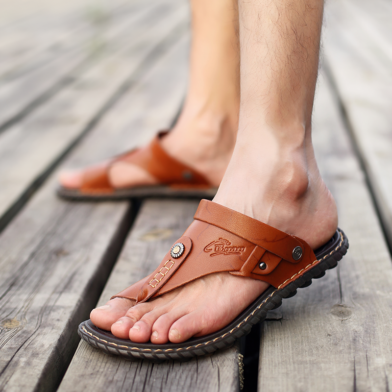 Stylish breathable leather flip-flops sandals for men, perfect casual summer footwear on wooden deck.