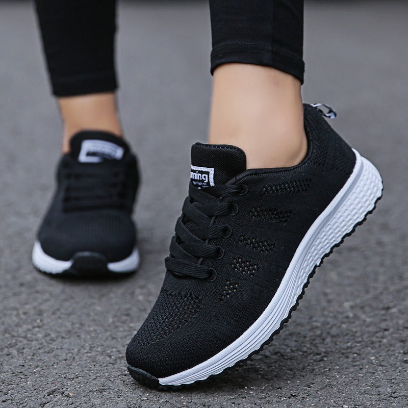 Women's breathable black mesh lace-up sneakers with flat sole for ultimate comfort and style.