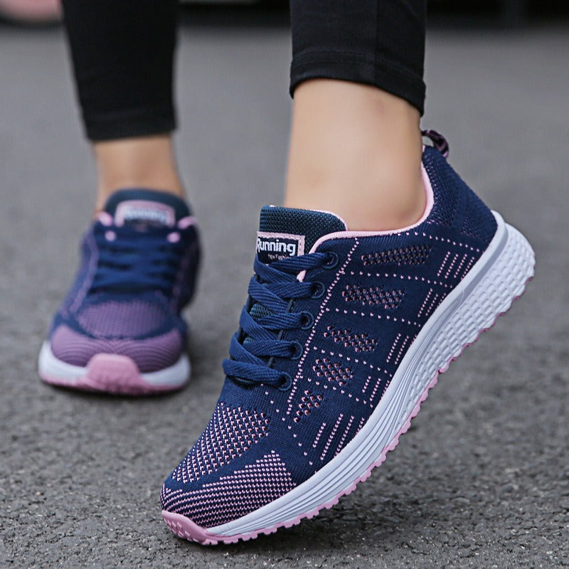 Breathable mesh lace-up sneakers in navy blue and pink for women, ideal for walking and running in comfort.