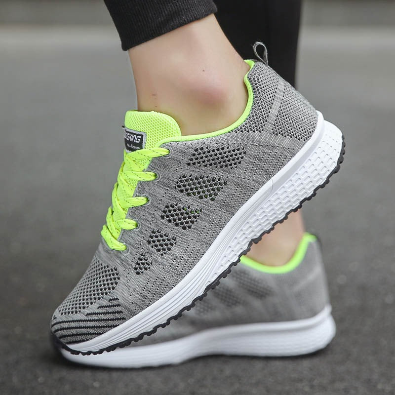 Stylish women's breathable mesh gray lace-up walking sneakers with neon accents for maximum comfort.
