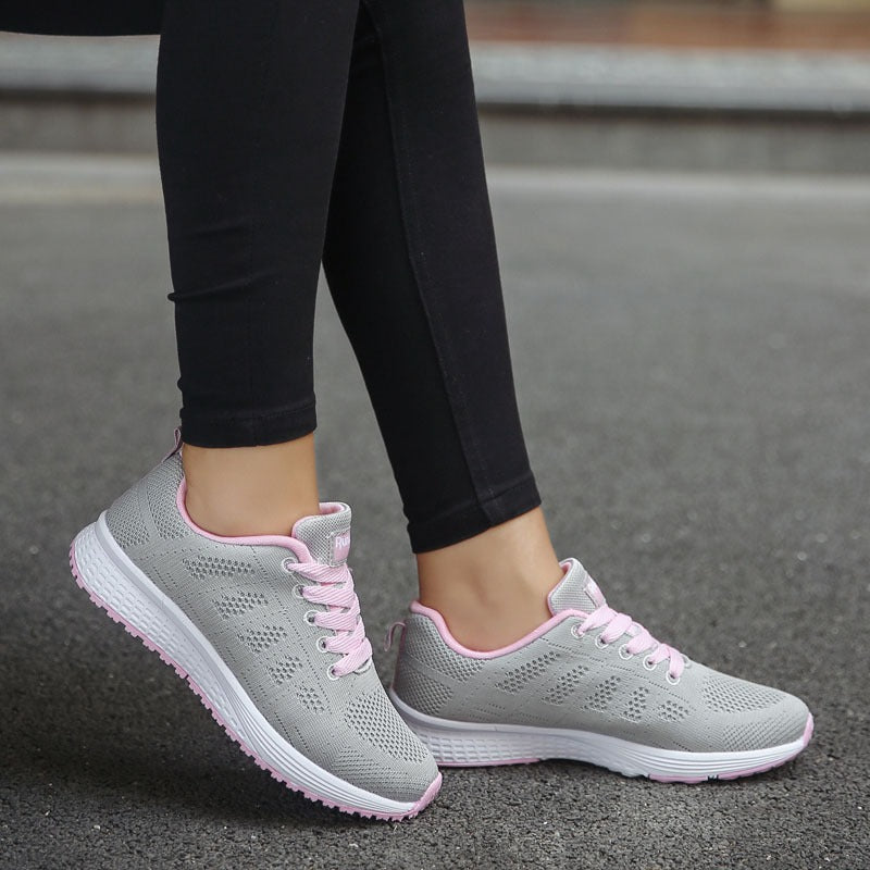 Women's breathable mesh lace-up flat sneakers in gray and pink, perfect for comfort and style.