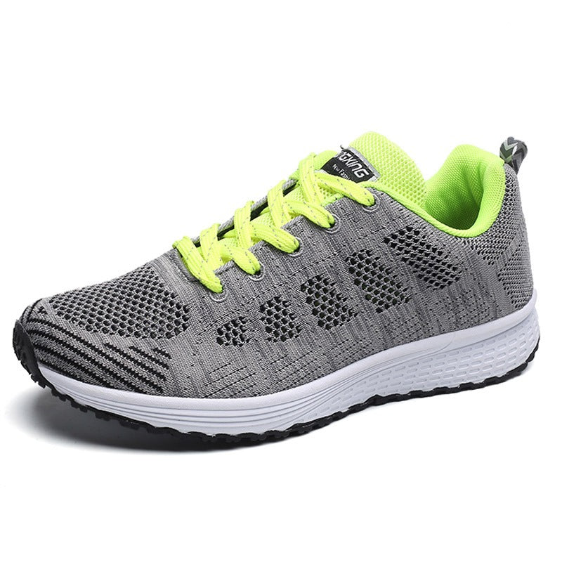 Breathable gray and neon green mesh lace-up flat sneakers for women, perfect for comfort and style.