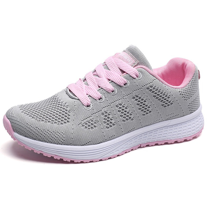 Women's breathable gray mesh lace-up flat sneakers with pink accents for comfort and style.